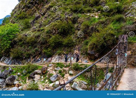 hikers standing   bridge waving  chalal trek trail sosan