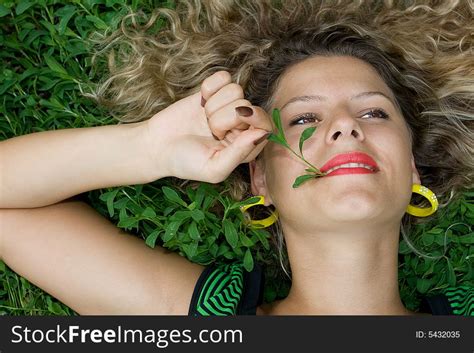 beautiful girl lying down of grass free stock images and photos