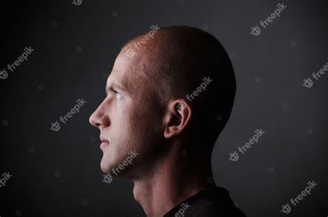premium photo profile  white bald man   twenties  dark