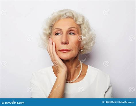 thoughtful serious senior woman feeling blue worried about problems