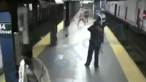 terrifying video shows man pushing woman  nyc subway tracks