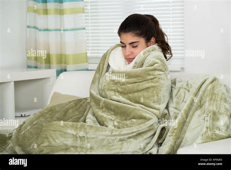 woman covered  blanket suffering  cold stock photo alamy