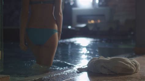 attractive female is dropping her towel before walking into pool in a spa by gorodenkoffs