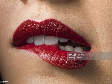 Female With Red Lipstick Biting Lips Close Up Photo Getty Images