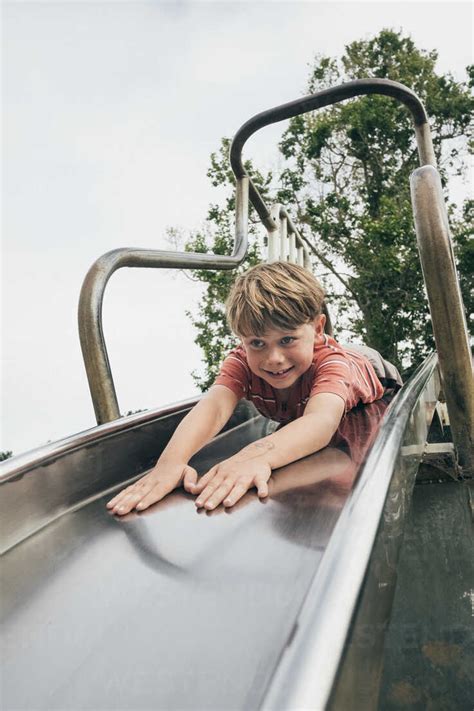 young boy sliding    stomach santa barbara california usa stock photo