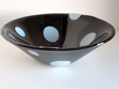 A Black And White Bowl With Polka Dots On It