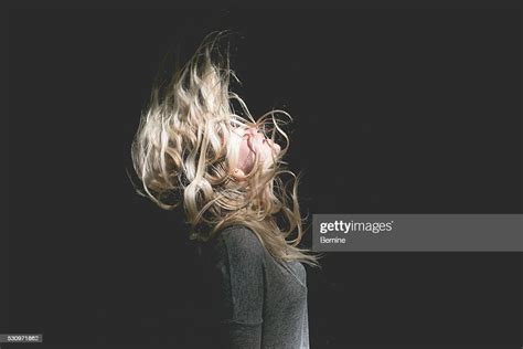 blonde female with hair over face foto de stock getty images