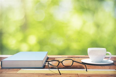Book Cup Of Coffee And Eyeglasses On A Vintage Wooden