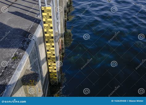 flood measuring rod   quay pier attached   ladder   dark water   baltic