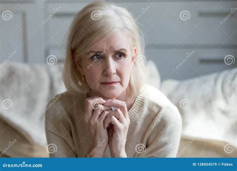 thoughtful upset mature lady crying thinking of loneliness or gr stock