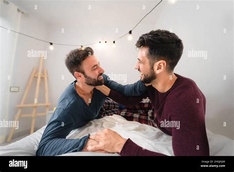 happy gay couple having tender moments in bedroom homosexual love