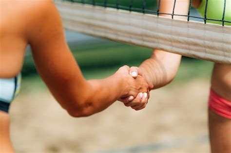 premium photo beach volleyball girls shaking hands after the match