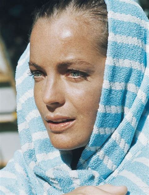 a woman wearing a blue and white towel around her head looking off to