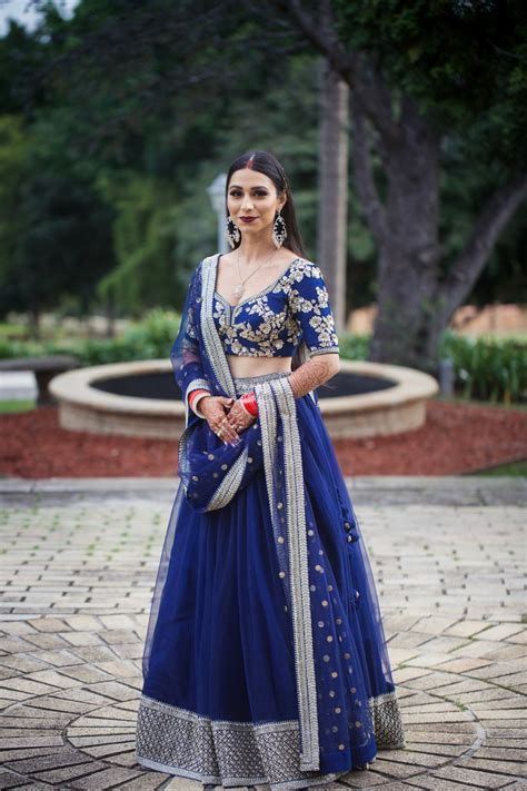 photo of bride in dark blue designer lehenga