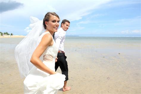 Newlywed Couple Running At The Beach Stock Image Image Of Marriage