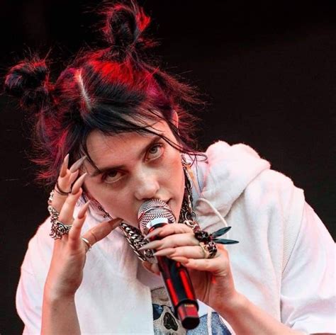 woman holding  microphone    face  wearing punk clothing  piercings