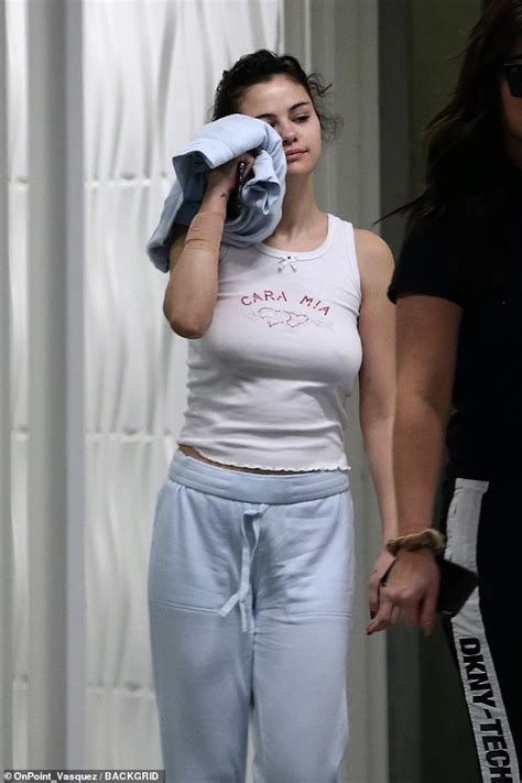 selena gomez goes braless in white tank top and sweatpants as she