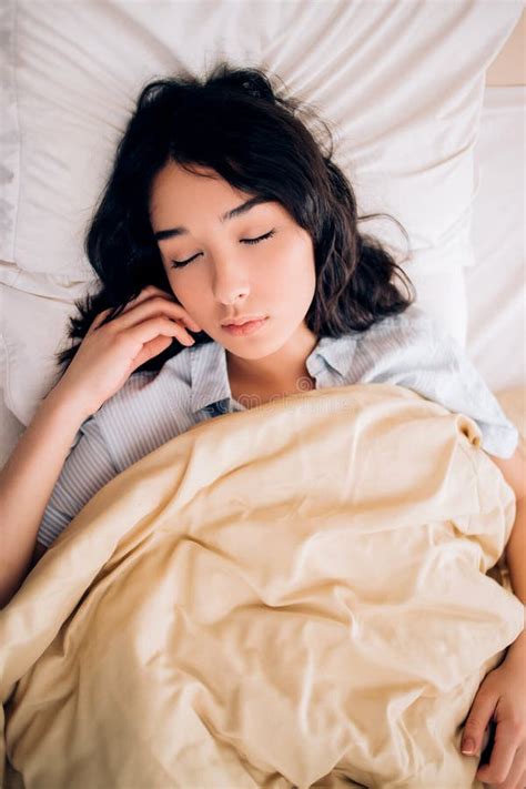 Young Beautiful Woman Sleeping In Bed Relaxing In The Morning Stock