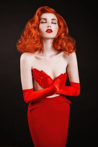 Redhaired Woman With Curly Hair In Red Dress And Long