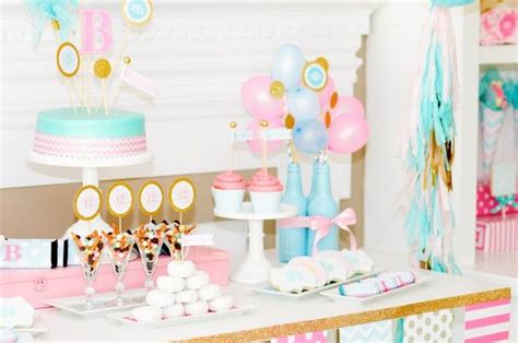 A Table Topped With Lots Of Cake And Balloons