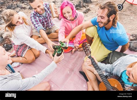 Group Of Friends Toasting And Drinking Beers On The Beach Happy Young