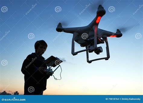 young man operating  flying drone  sunset stock photo image  motion sunset