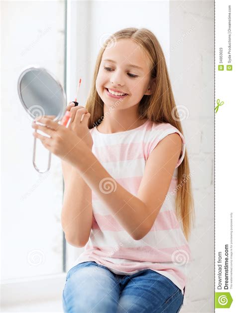 teenage girl with lip gloss and mirror stock image image