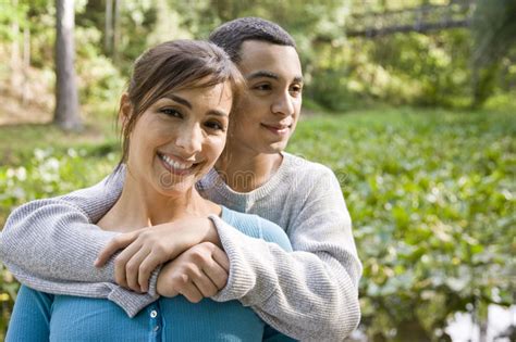 portrait of hispanic mother and teen son outdoors stock