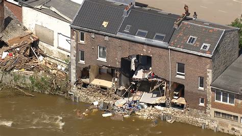 footage shows damaged homes  debris lined streets  river
