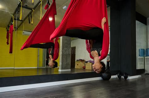 young sporty african woman practicing aerial flying yoga stretching