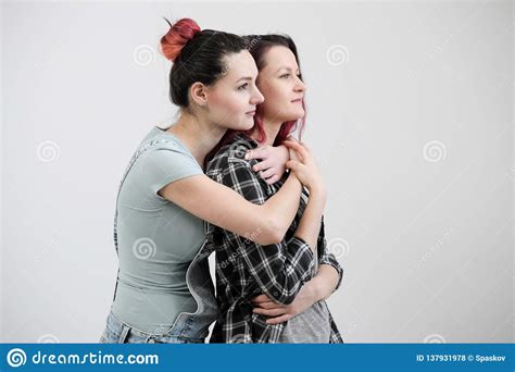 Two Girls Hug On A White Background Homosexual Lesbian