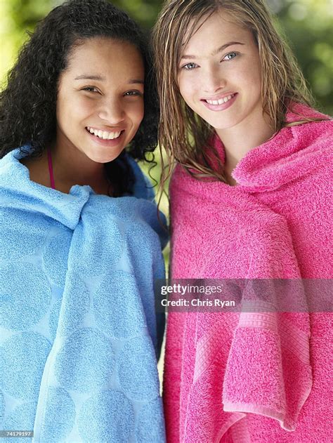Two Teenage Girls Wrapped In Towels Outdoors In Summer Smiling High Res