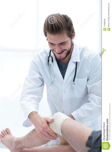 doctor treats  patients leg stock photo image  healing bandaged