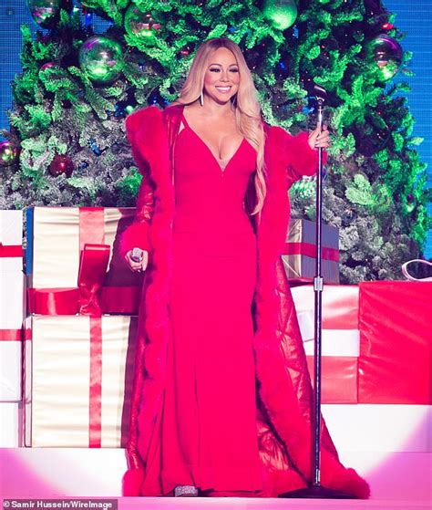 mariah carey stuns in a festive white coat as she continues her all i want for christmas is you