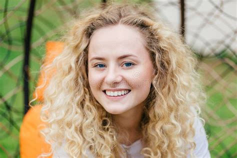 Photo Of Attractive Curly Blonde Female With Shining Smile Shows White