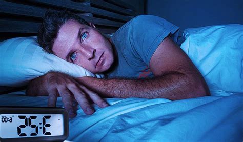 Restless Worried Young Attractive Man Awake At Night Lying On Bed