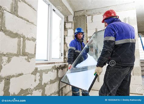 windows installation  construction workers installing glass stock photo image  person