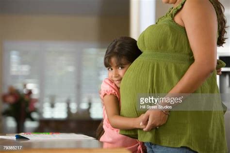 9 year old girl with pregnant mother photos and premium high res