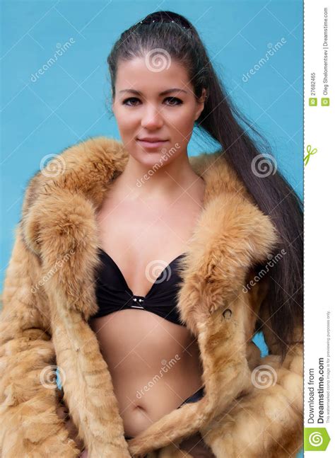 beautiful naked woman in a fur coat royalty free stock
