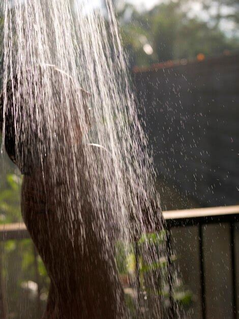 premium photo woman taking an outdoor shower in bali