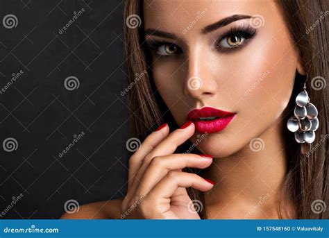 Seductive Woman With Dark Brown Eye Makeup And Bright Red Lips And