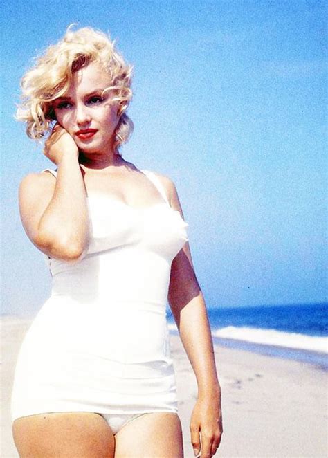 a pregnant marilyn monroe poses on a beach in amagansett ny