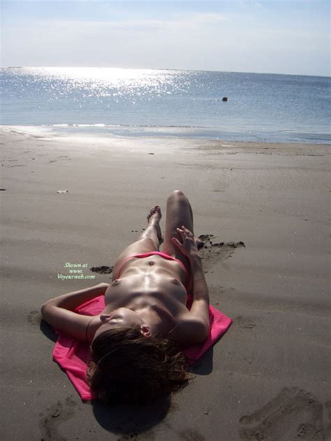 lying topless on beach alone august 2007 voyeur web hall of fame