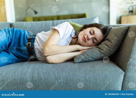 Young Attractive Girl Sleeping On The Couch In The Living Room Stock