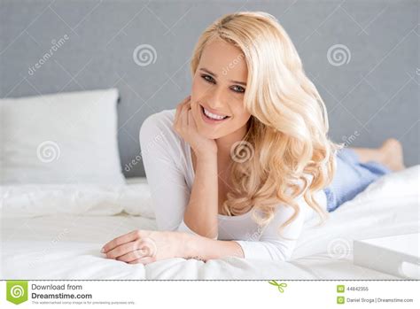 gorgeous blond woman lying on her bed stock image image of looking