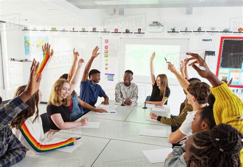 high school students  hands raised  debate class stock photo