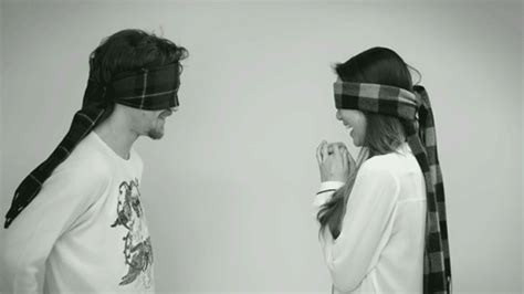 blindfolded strangers kiss each other in an adorable