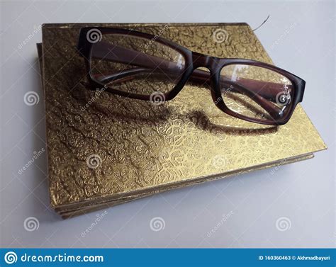 A Gold Cover Reading Book And Sunglasses Isolated A White Background