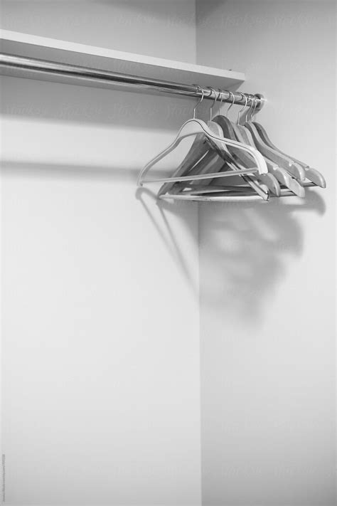 coat hangers on a metal rack by stocksy contributor jovana rikalo