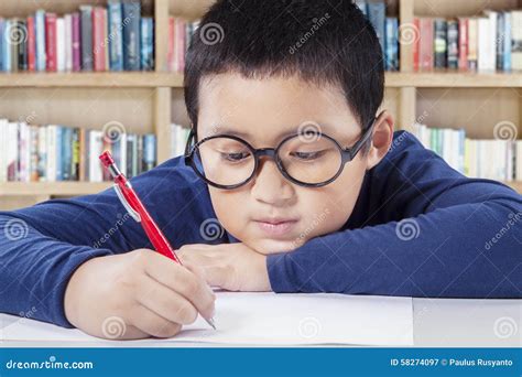 student writing   paper   library stock image image